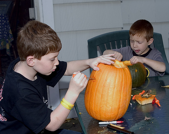 the boys carving their pumpkins